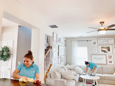 Merry Maids experts cleaning a living room during maid service in Lancaster